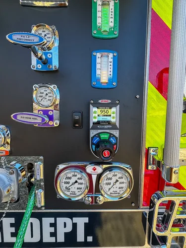 Pump panel close-up showing pressure gauge and rotary selector control.