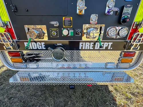 Straight rear view of the truck with full pump control panel exposed.