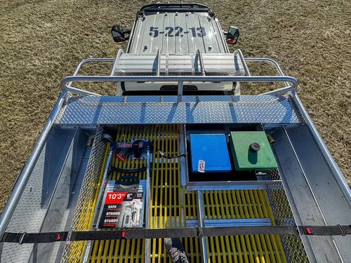 Top-down view over the rear deck with equipment compartments and rails.