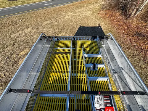 Top-deck close-up showing grated walkway sections and mounted components.