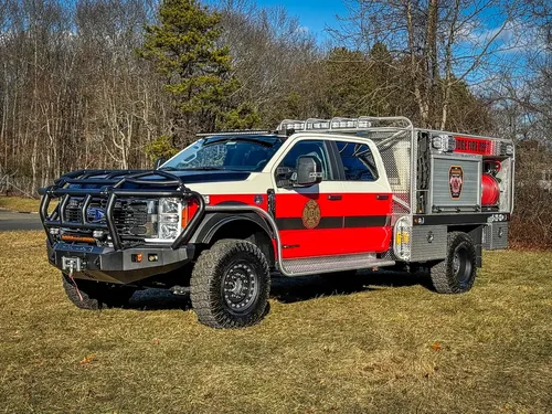 Front-left exterior view with brush guard and side body visible.