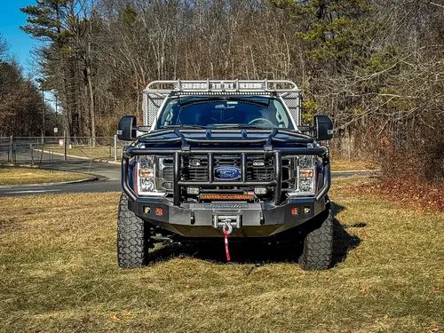 Head-on front view showing grille, brush guard, and bumper winch.