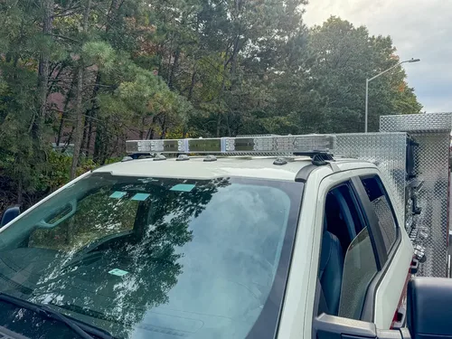Cab roof close-up with lightbar modules and roof-mounted equipment.
