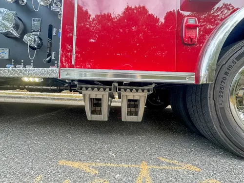 Lower side body close-up with fold-out step under compartment.