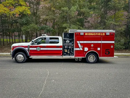 Left-side profile showing cab and rear rescue body.