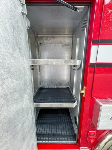Compartment interior close-up showing upper shelf and clean walls.