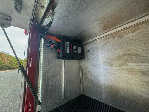 Open side compartment interior with charger mounted at upper corner.