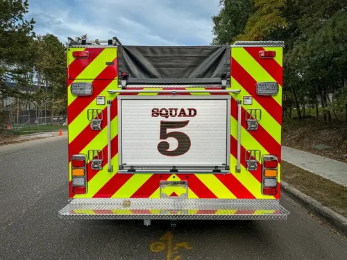 Straight rear view with Squad 5 roll-up door and chevrons.