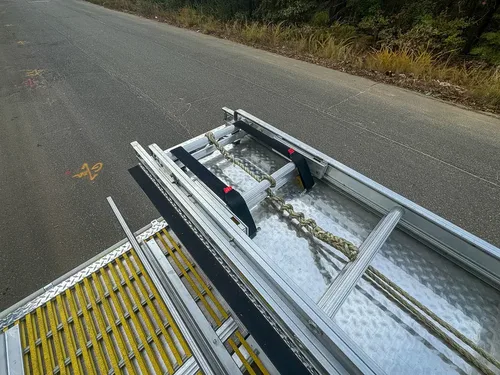 Top deck view with ladder, handrails, and open center deck panels.