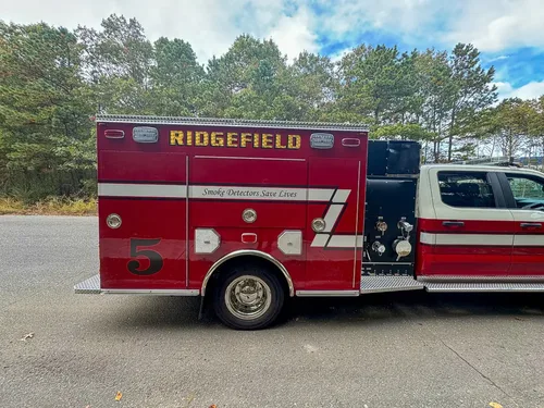 Right-side profile with large side compartment doors open.