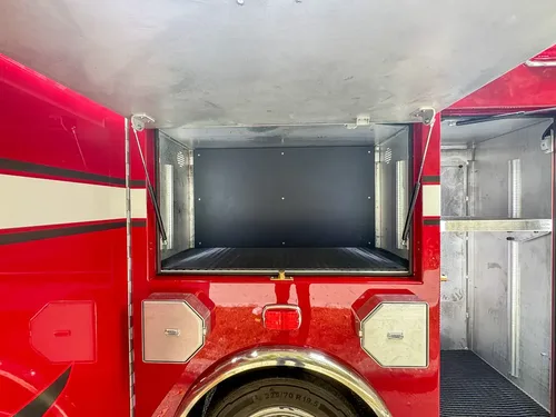Rear-center compartment open with deep storage cavity.