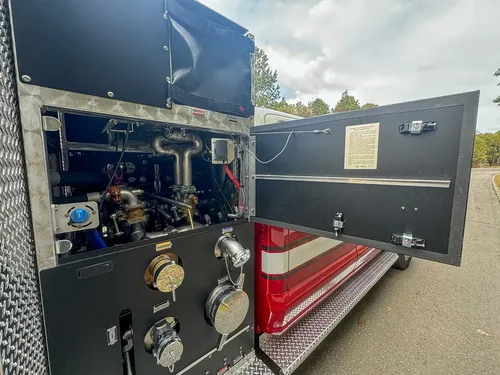Open side pump compartment with valves and plumbing exposed.