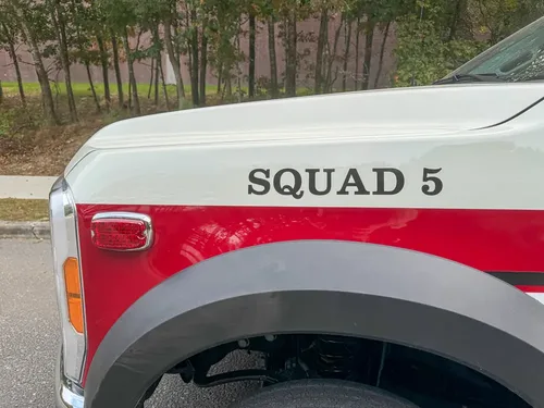 Rear fender close-up with Squad 5 lettering and panel seam.