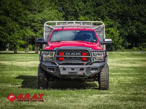 Exterior view of small fire truck showing cab, body compartments, and wheel/tire area.