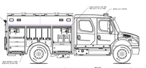 Exterior view of small fire truck showing cab, body compartments, and wheel/tire area.