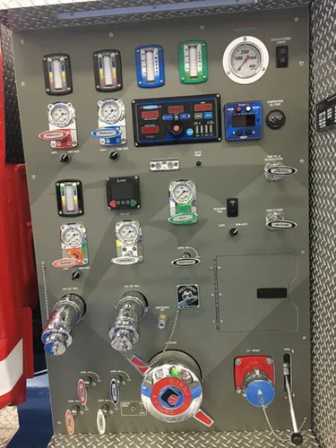 Exterior view of small fire truck showing cab, body compartments, and wheel/tire area.