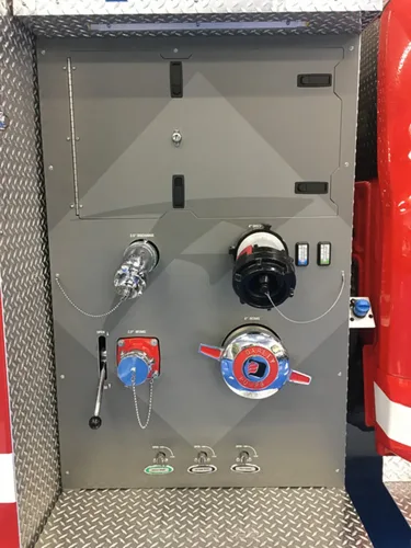 Exterior view of small fire truck showing cab, body compartments, and wheel/tire area.