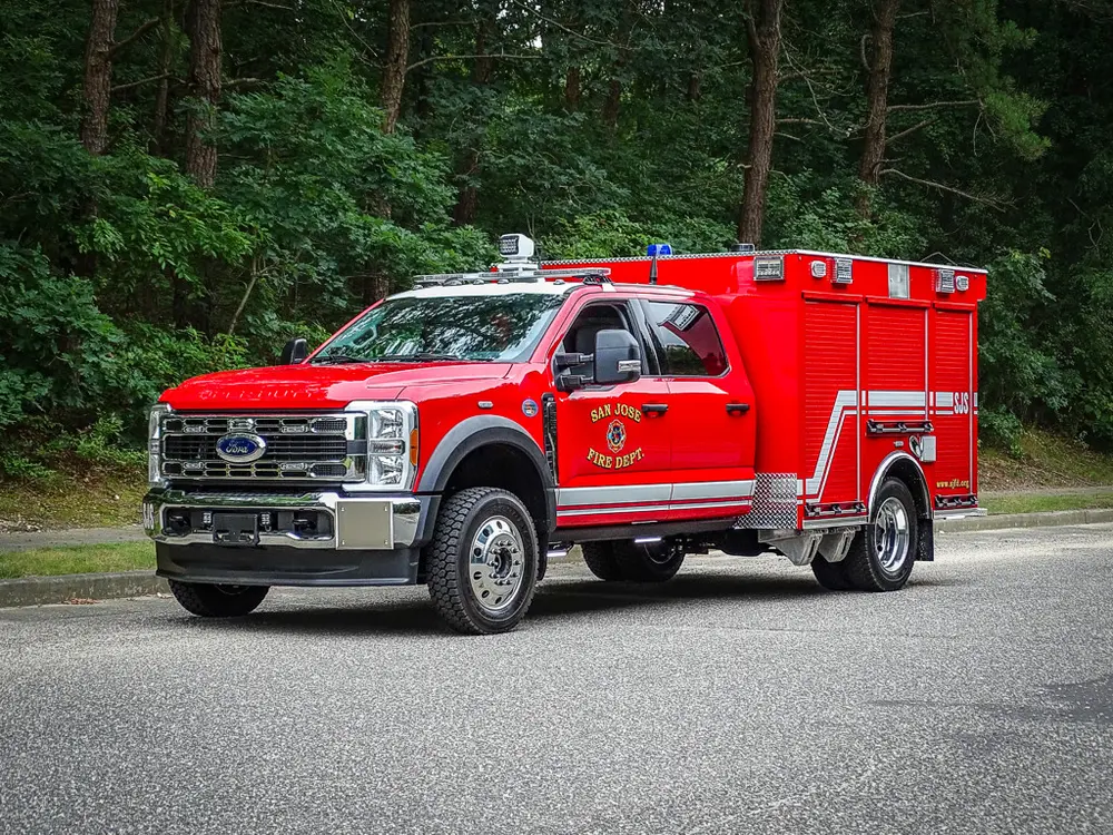 Front-left three-quarter exterior view of the red rescue-style truck.