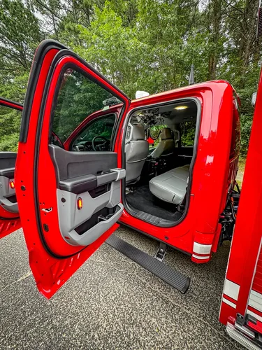 Open rear passenger door view showing rear seat area.