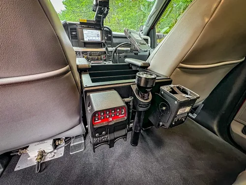 Rear floor area between front seats with mounted control equipment.