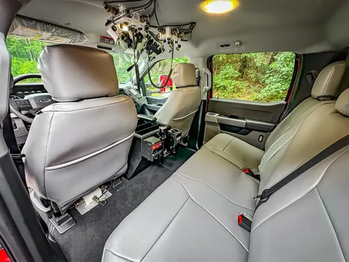 Rear cabin seating view with front seatbacks and center floor console.