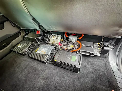 Rear floor electronics modules and wiring under folded panel.