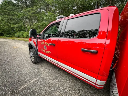 Left-side exterior profile of crew cab with body stripe and emblem.