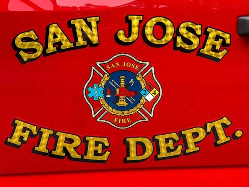 Tight close-up of San Jose Fire Dept emblem and lettering on red panel.