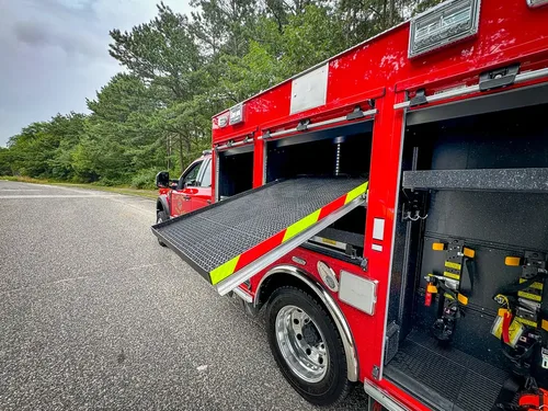 Wide right-side view with multiple compartments open and large slide-out tray extended.