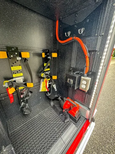 Close-up of vertical equipment panel with orange wiring and switches.