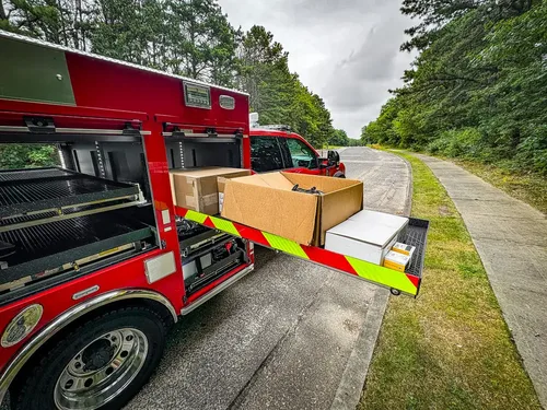 Side compartments open with large tray extended and box on shelf.