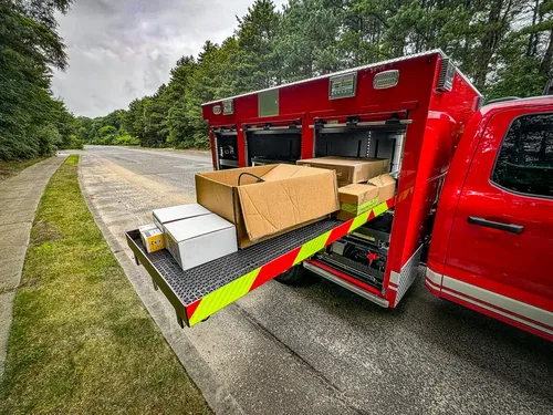 Long side slide-out tray fully extended with boxes on top.