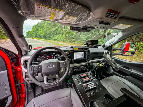 Wide cockpit view from driver side showing dashboard and center stack.