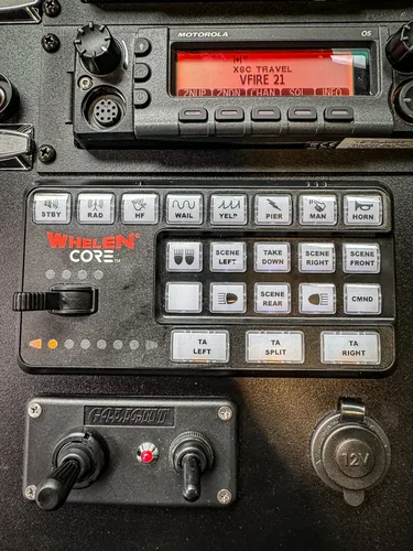 Whelen control keypad close-up with labeled emergency buttons.
