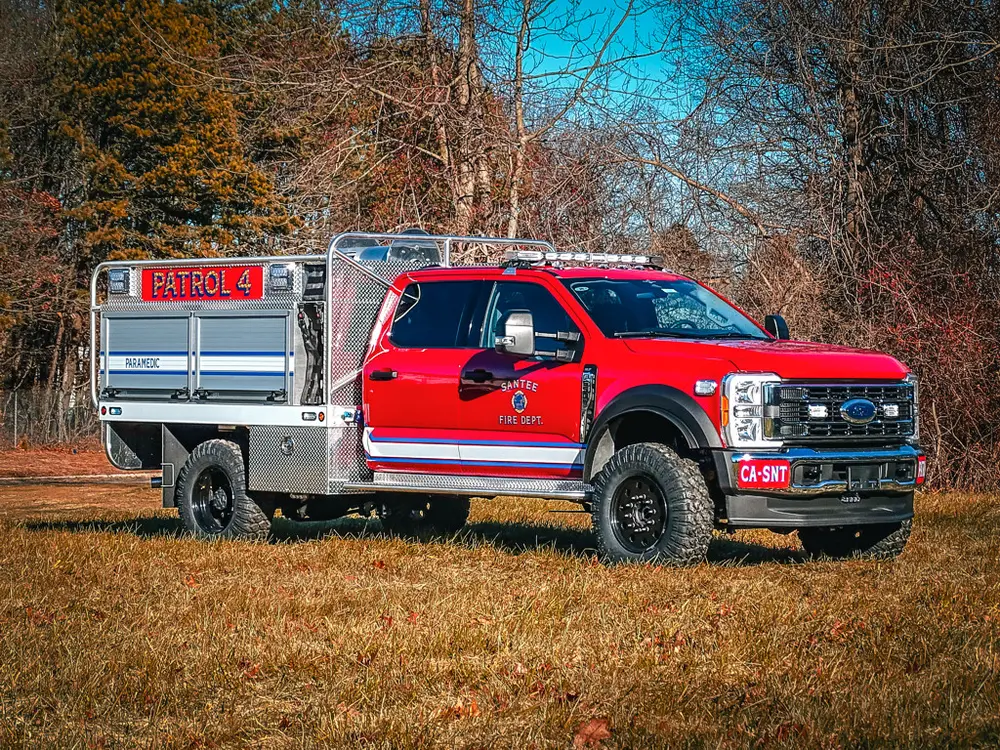 Front-left three-quarter exterior view of red patrol-style brush truck.