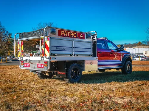Rear-right angle with side rails and open rear equipment area.