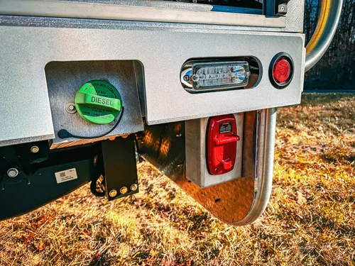 Rear corner close-up with intake cap, taillight, and lower hitch area.