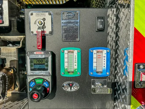 Pump control panel close-up with engine control module and indicators.