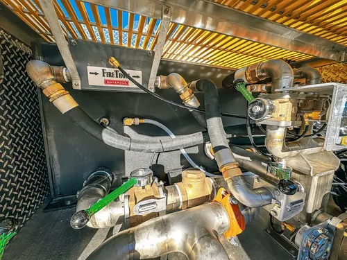 Pump bay interior close-up with fittings and control links.