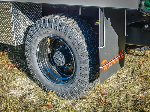 Rear wheel and mudflap close-up from right side.