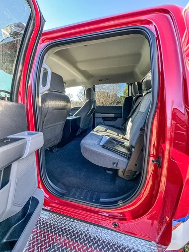 Open rear door view showing rear seat and floor area.