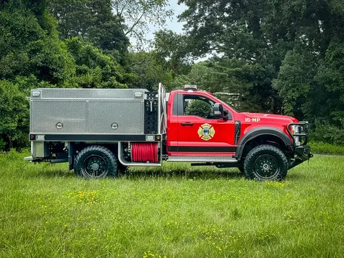 Full right-side profile of truck parked on grass.