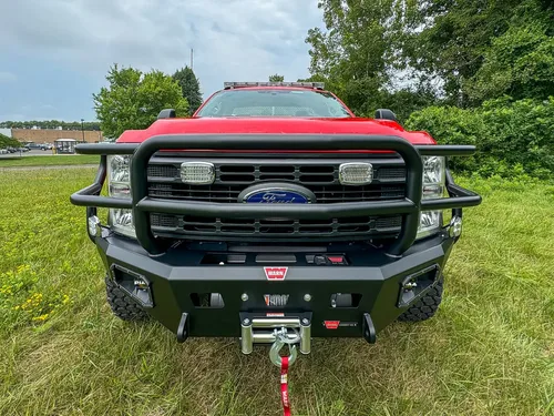 Head-on front exterior view showing grille guard and bumper winch.