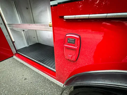 Open lower side compartment beside wheel arch and side marker light.