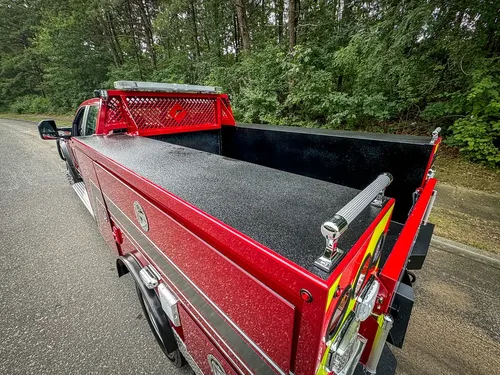 Pickup-bed interior view from rear-left corner with sidewalls raised.