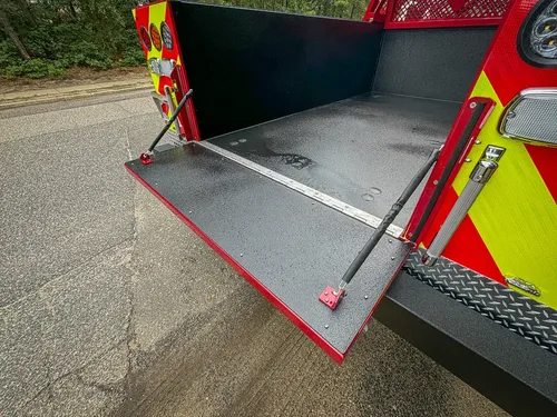 Tailgate support strut close-up on lowered rear gate.