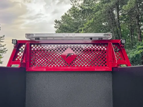 Rear upper rack and mesh panel view behind cab roof lights.
