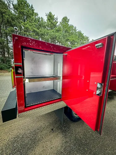 Open right-side rear compartment with shelving and clean interior.