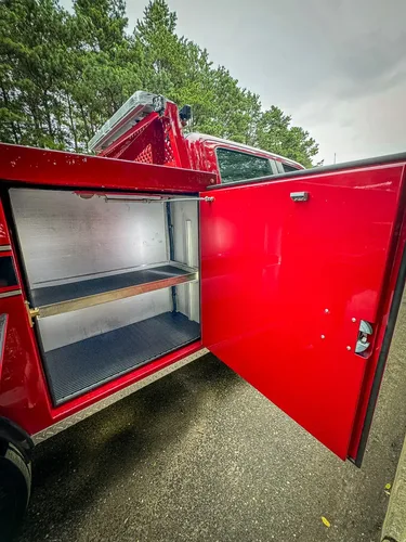 Open mid-side compartment with shelf and wiring visible at upper right.