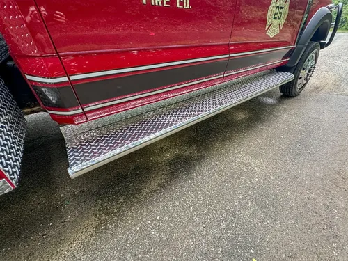 Lower cab side step and trim close-up along passenger door.